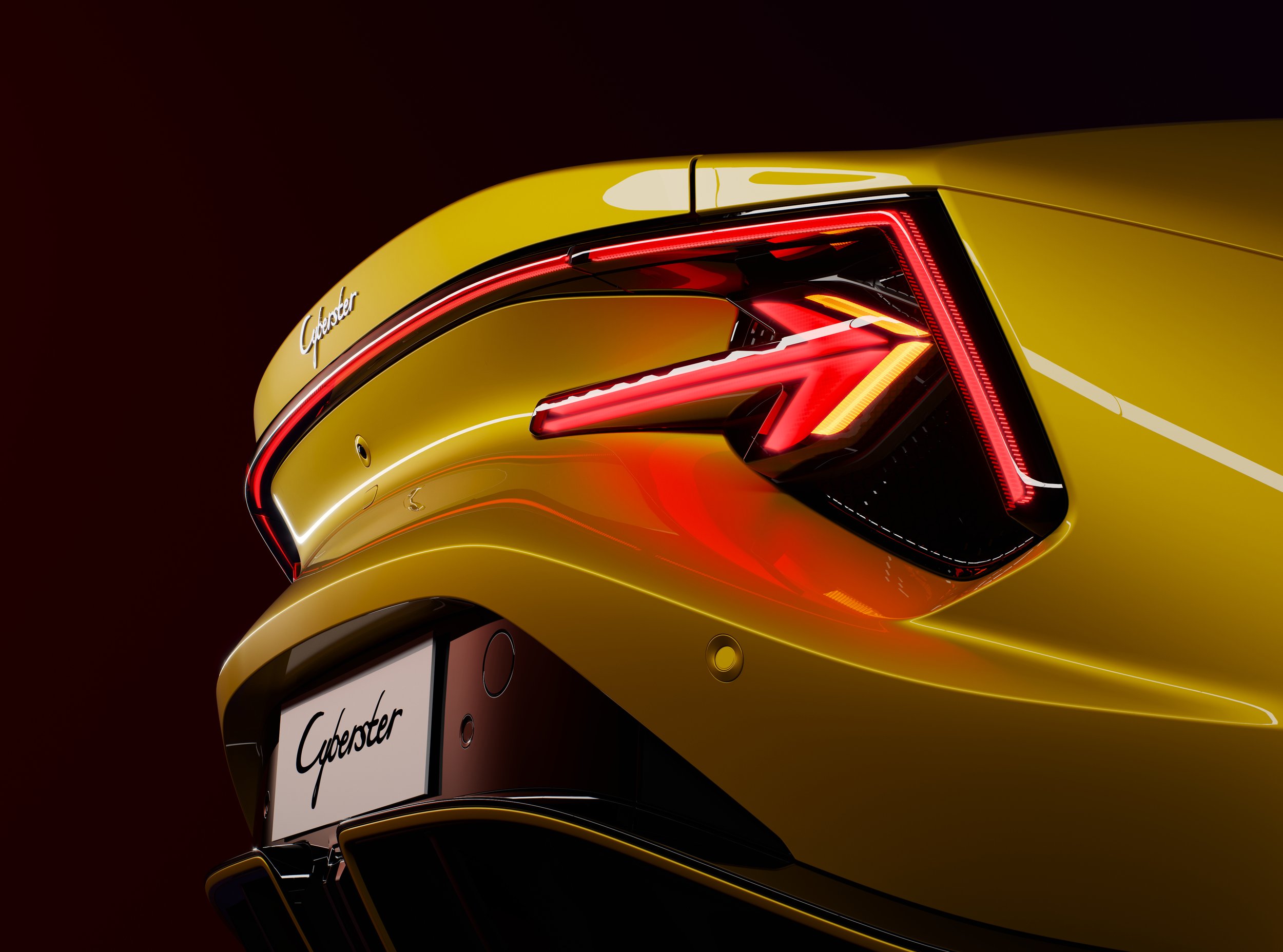 Close-up of the rear of a yellow luxury car, featuring an illuminated taillight and the model name 'Cybersster' on the license plate.