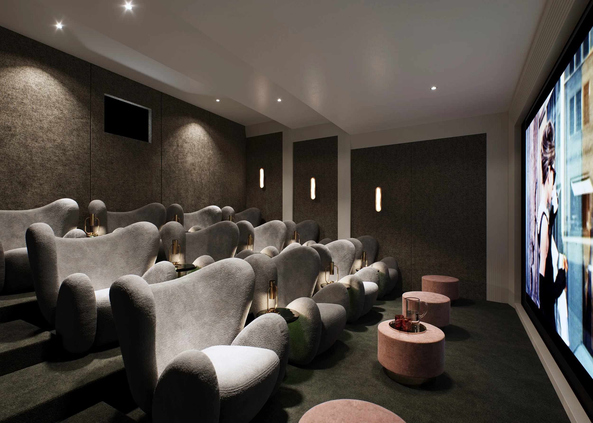 A modern movie theater with gray plush seats arranged in rows, small side tables with drinks, and large screen displaying an image of a person walking with an umbrella.