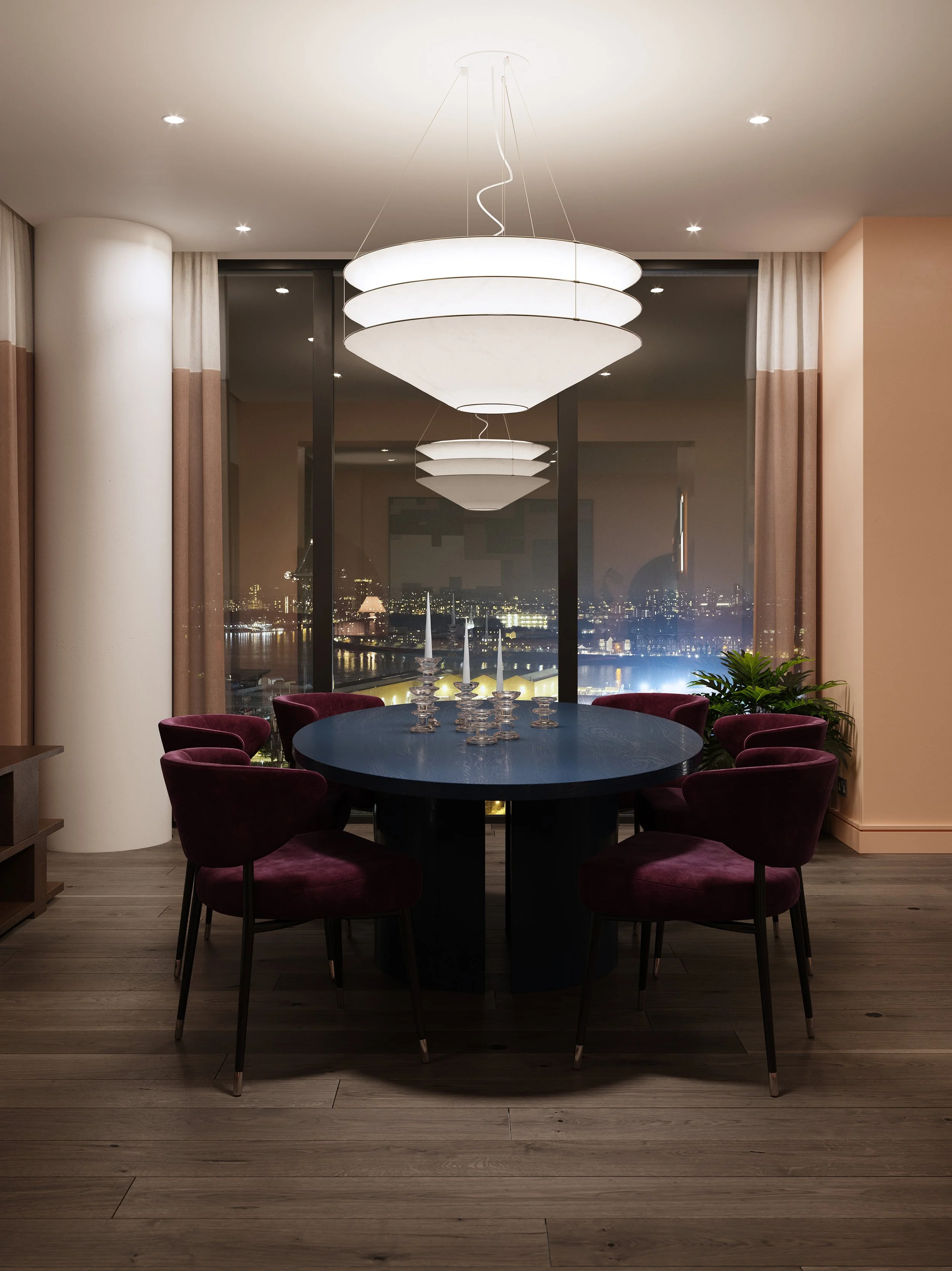 A modern dining room with a dark oval table and eight burgundy velvet chairs, candle holders in the center, large window showing a city skyline at night, and a white layered pendant light fixture hanging above the table.