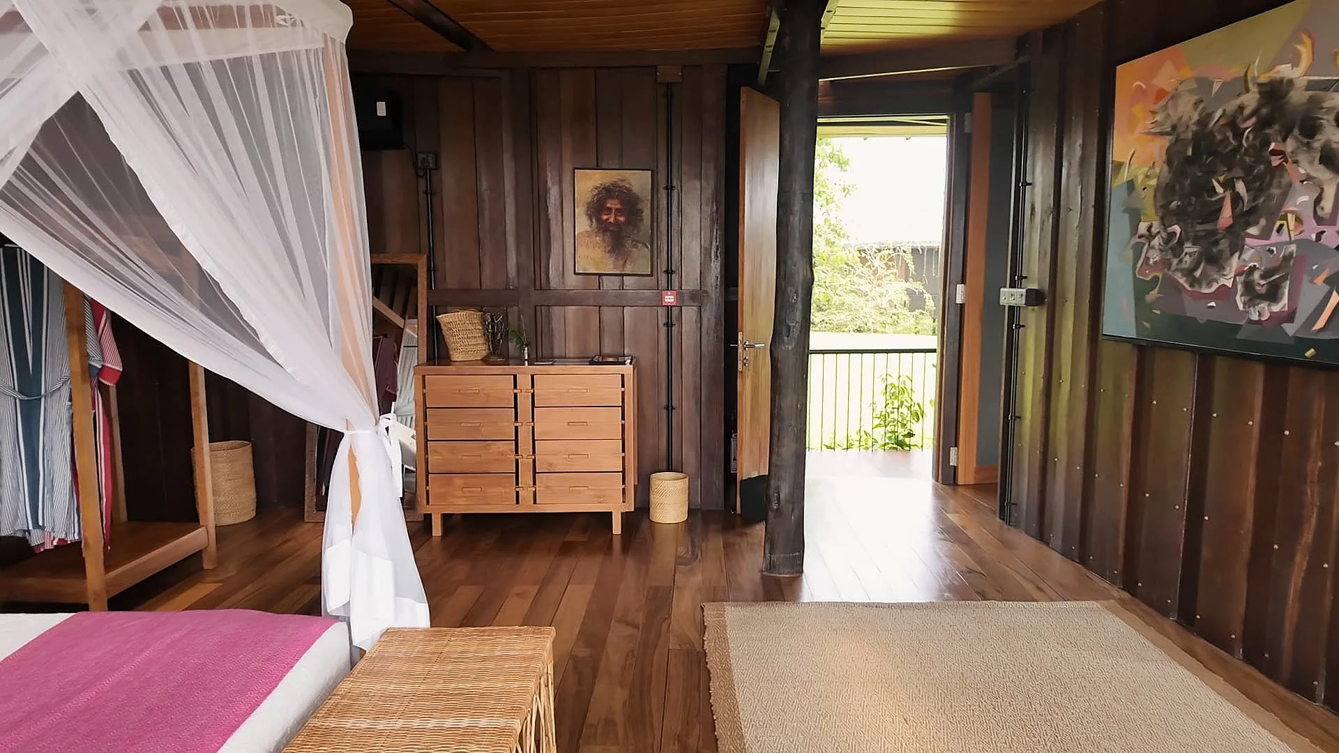 One of Trebartha East luxurious guest rooms with wooden furniture, ceiling, floors and walls and beautiful Sri Lankan art