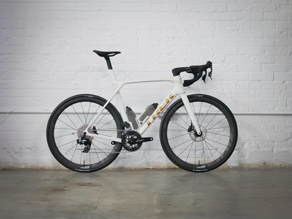 A white Trek Madone against a whitewashed brick wall at Rouleur Live