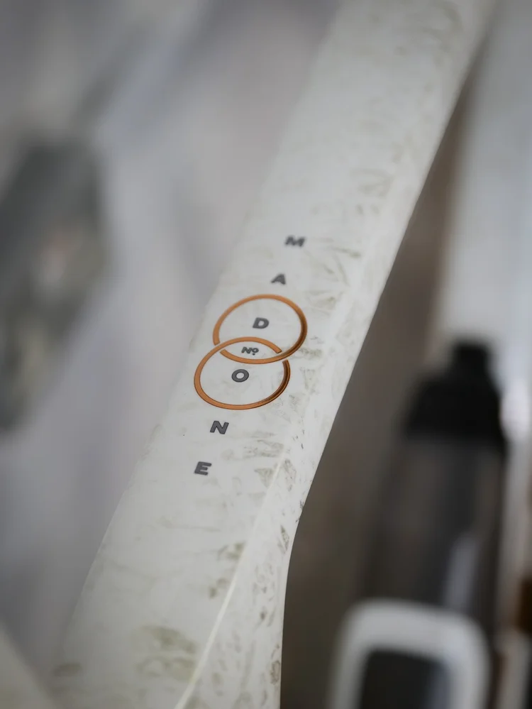 Madone logo detail on a white frame