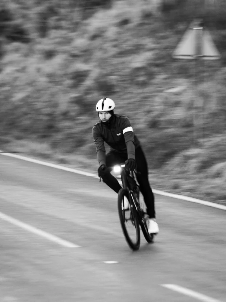 Black and white of Daniil descending a mountain road at speed