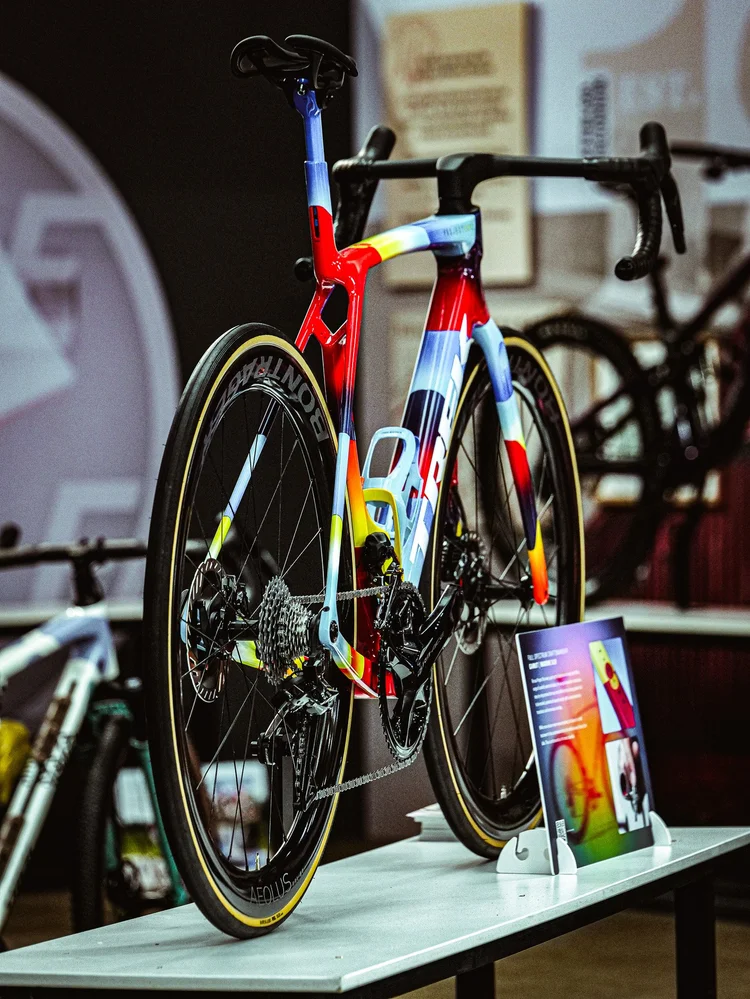 A hand-painted multicolour race bike on a display plinth