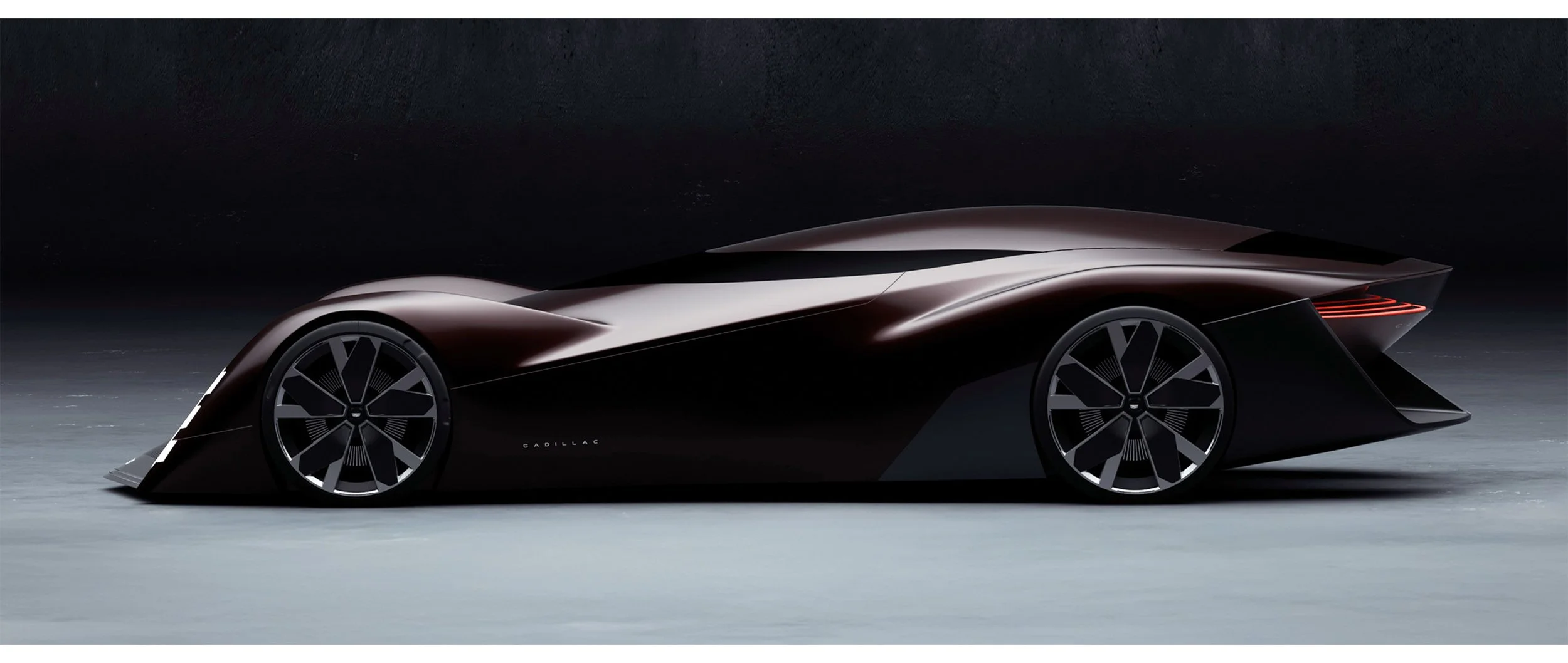 A sleek, futuristic black concept car with aerodynamic design, large modern wheels, and glowing red taillights, set against a dark background.