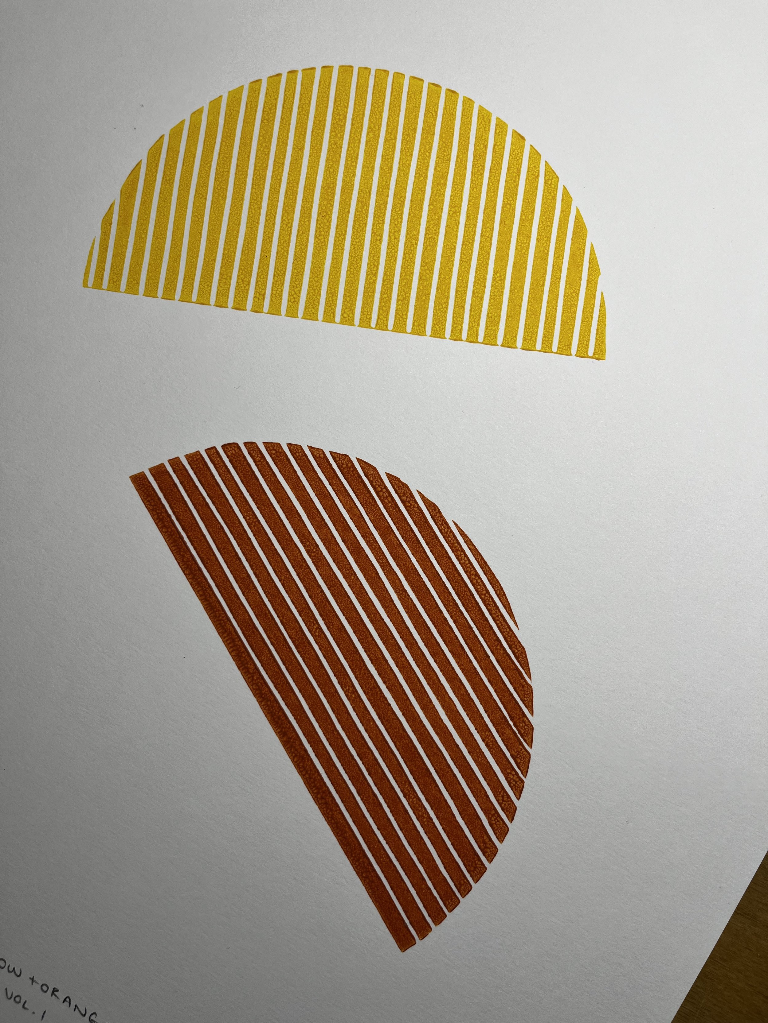 Two semi-circular patterns with vertical stripes, one yellow and one orange, on a white background.