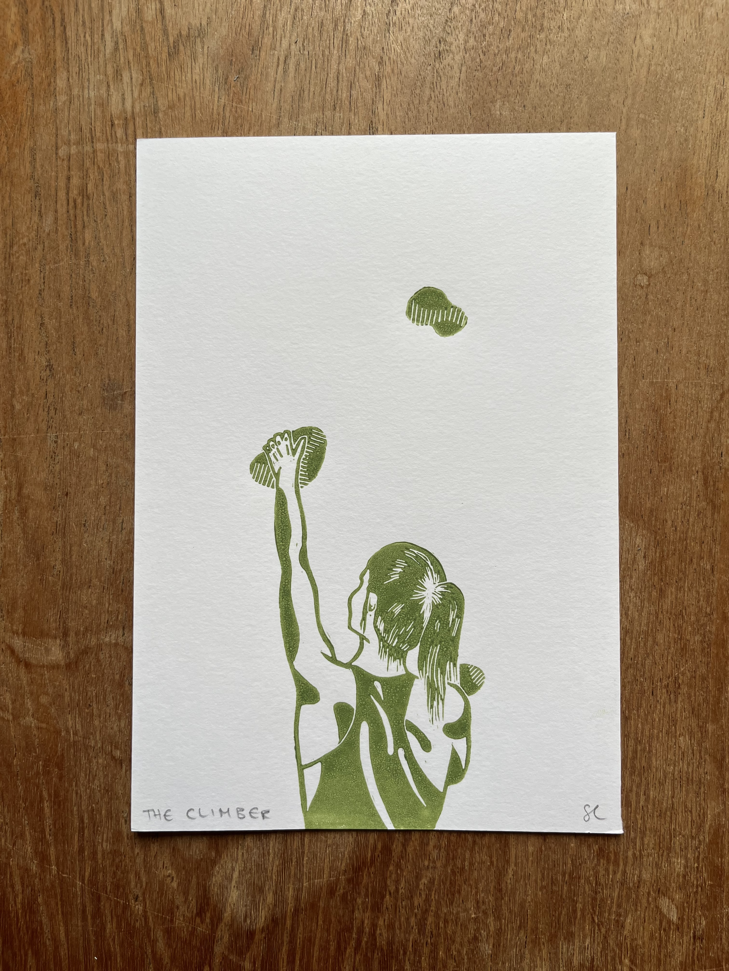 A drawing of a person climbing a tree, reaching up with one hand, with the phrase "The Climber" written on the bottom left corner.