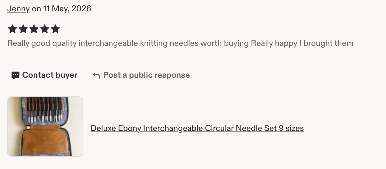 A case containing a set of nine interchangeable circular knitting needles with black handles and silver tips.