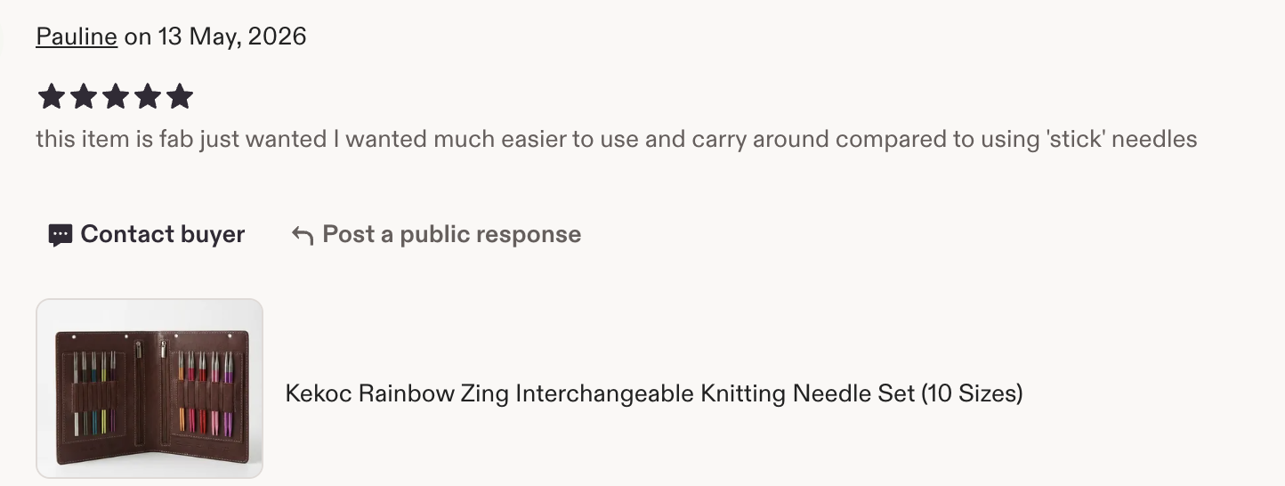 Photo of a brown knitting needle case with multiple colorful knitting needles organized in slots.