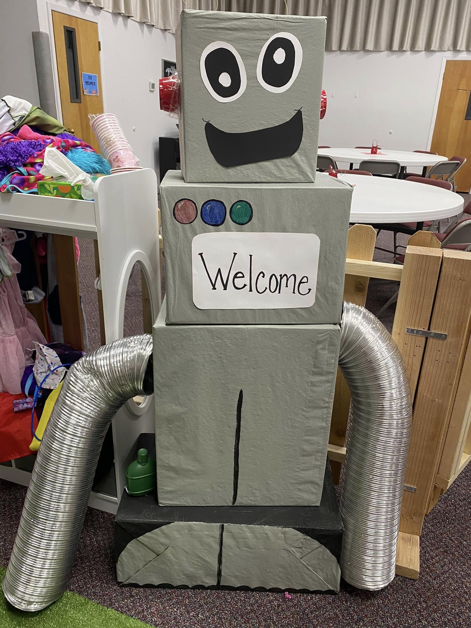A DIY carboard robot greets visitors to a preschool classroom