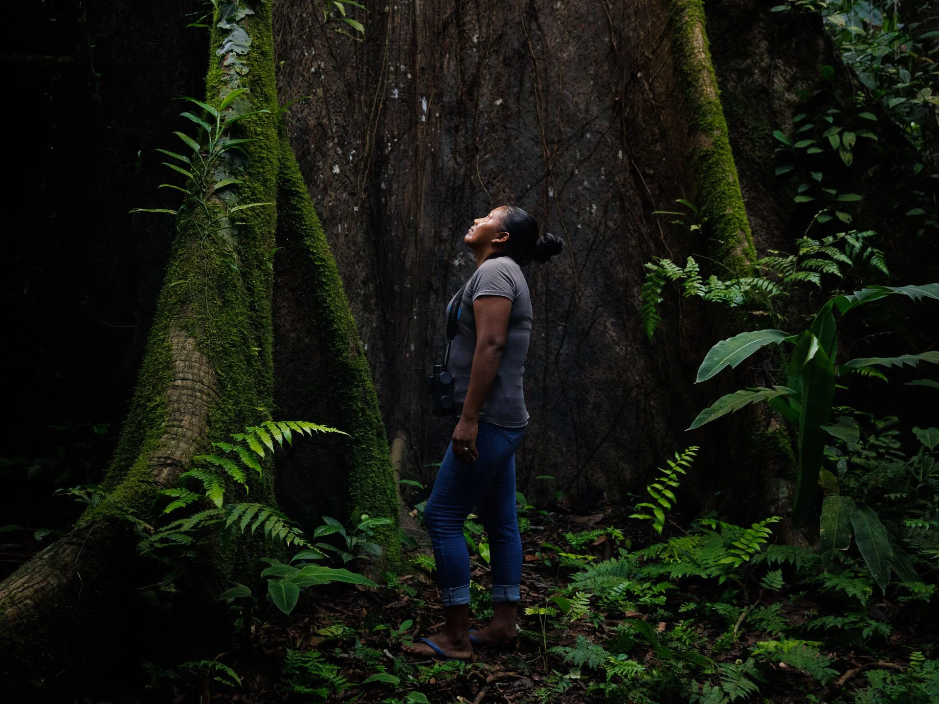 Woman standing under a tree in the jungle of Guyana