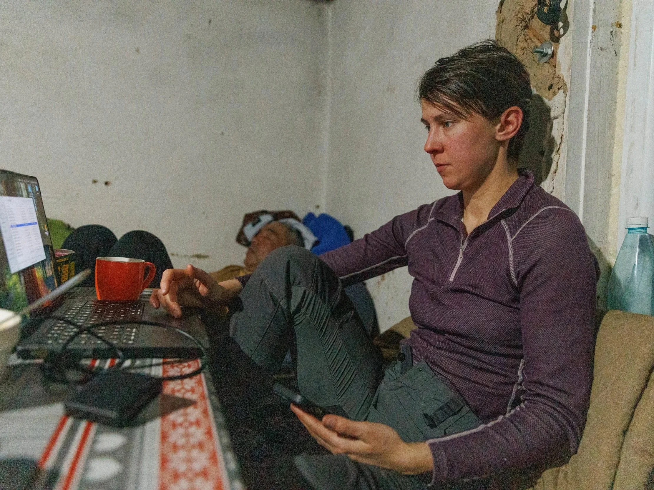 A woman with a laptop tracking snow leopards in Kyrgyzstan