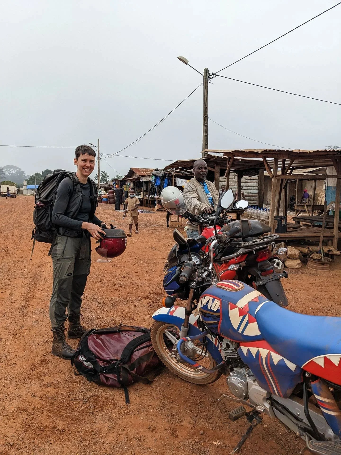 A woman next to a motorbike during a bespoke safari in West Africa