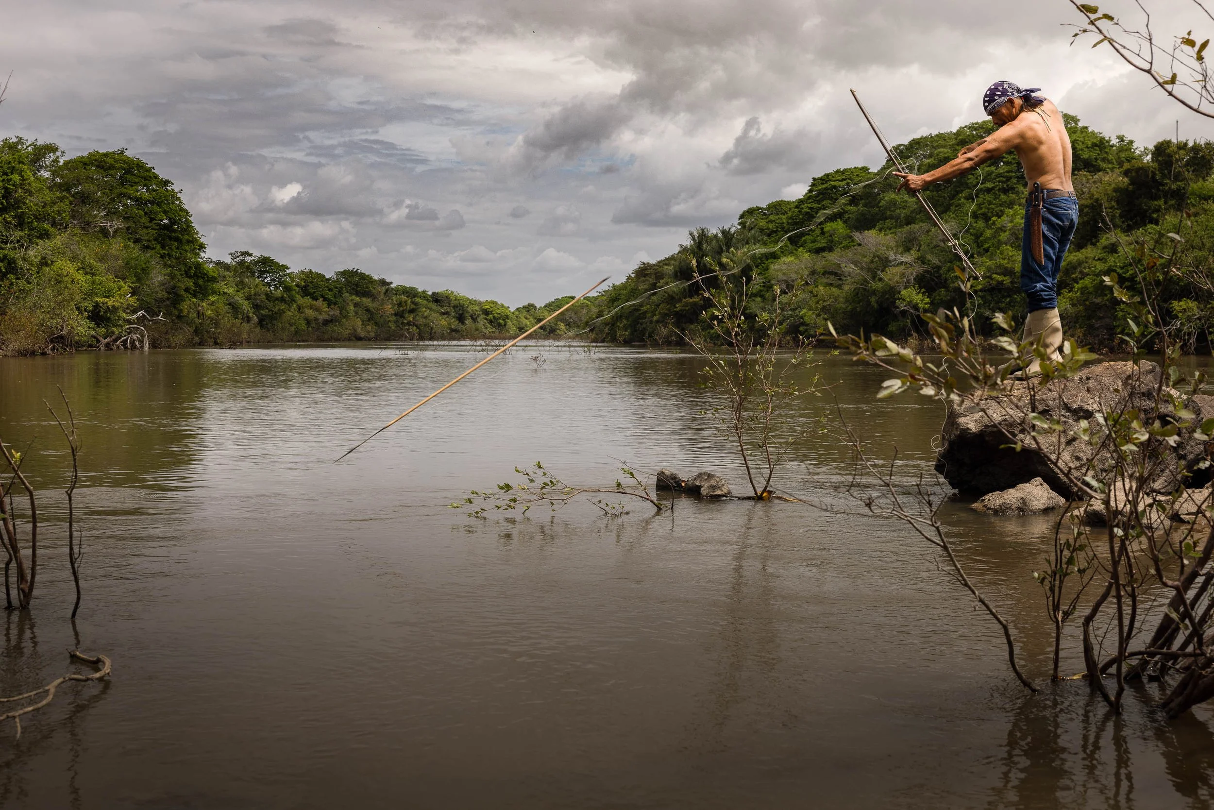 A man hunting for fish on an exclusive Amazon rainforest tour