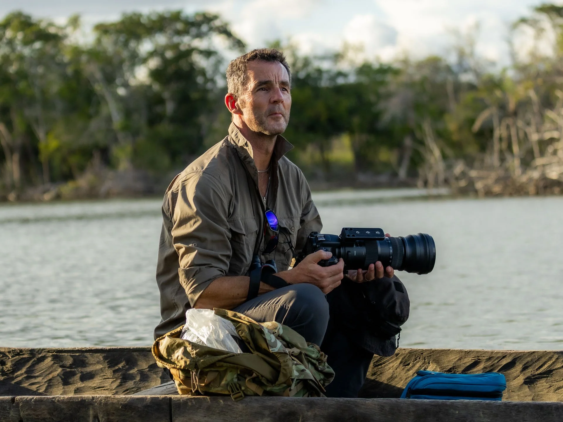 A photographer sits in a canoe during a guided rainforest tour in Guyana