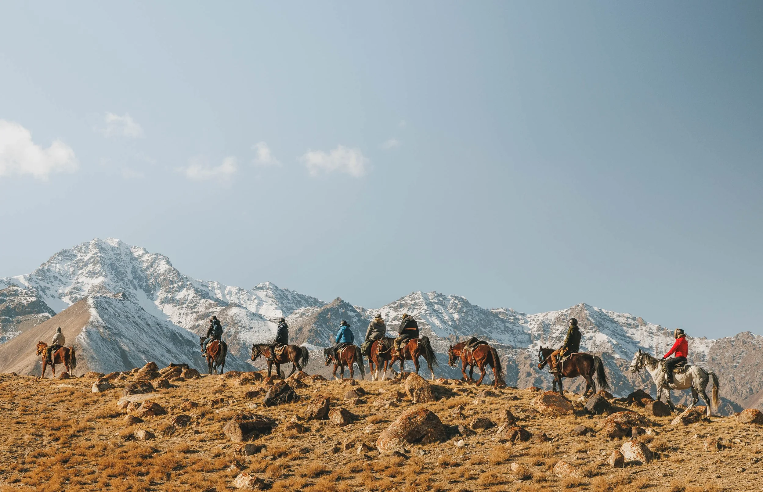 A person riding a horse on a snow leopard tour in Kyrgyzstan