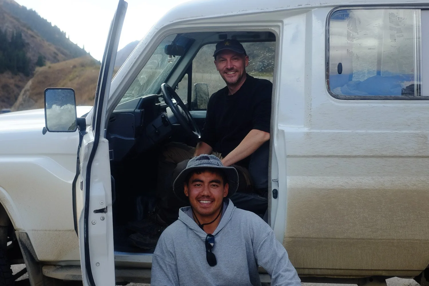 A horseman crosses a river on horseback in search of snow leopards in Kyrgyzstan