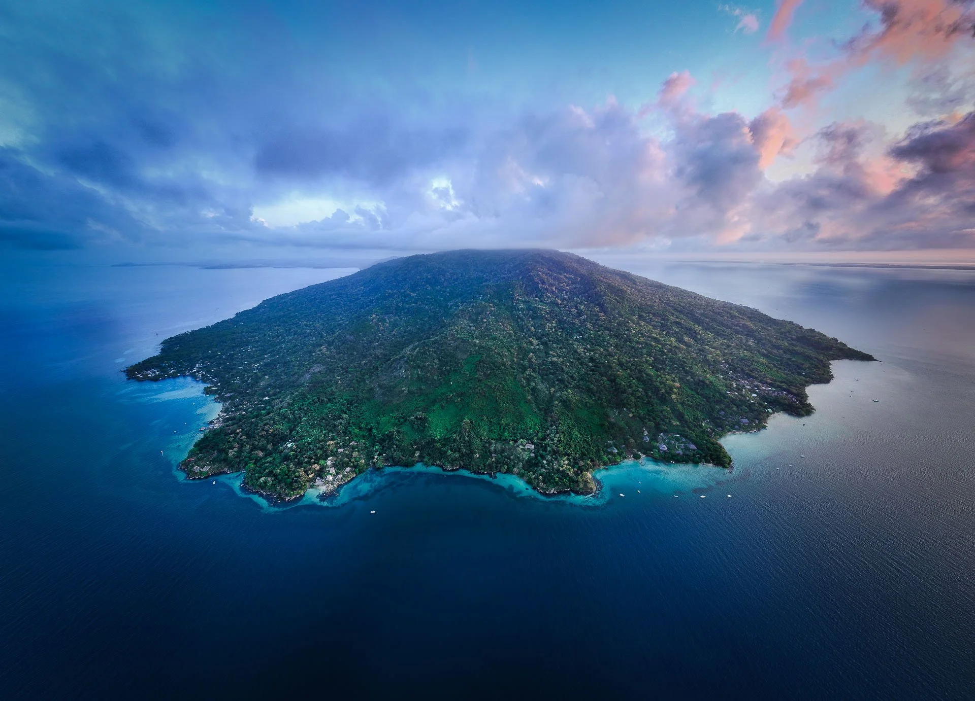 A green isolated and remote island in Nosy Be Madagascar on a small group marine tour