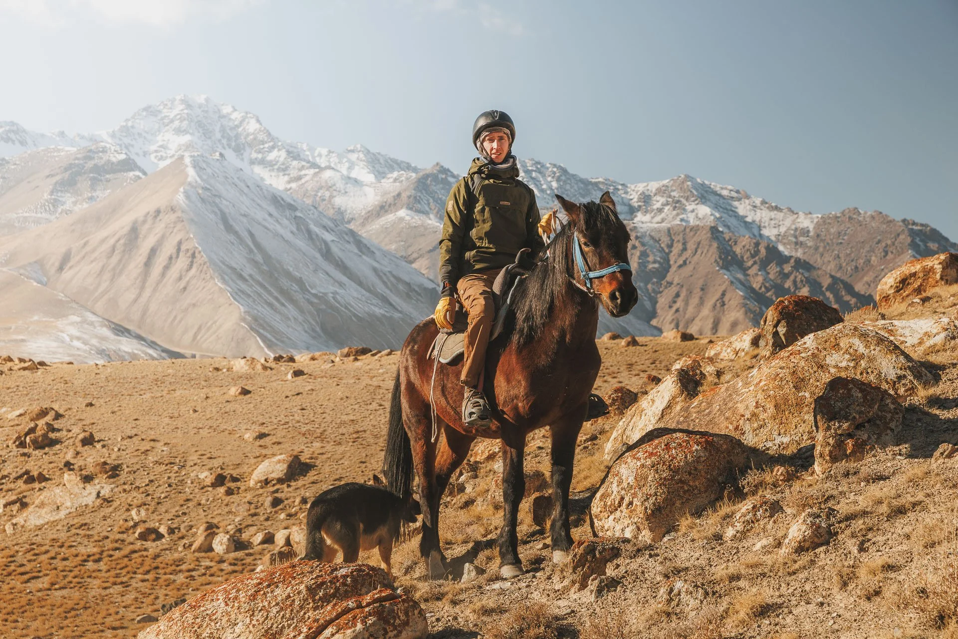 A person riding a horse on a snow leopard tour in Kyrgyzstan