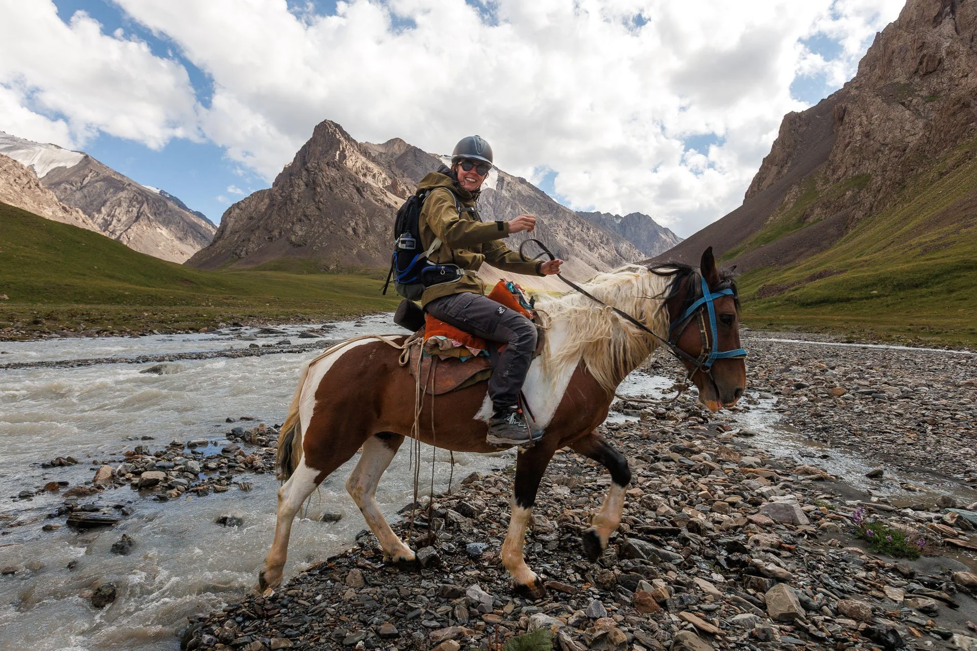 A horse rider smiling during a guided snow leopard holiday