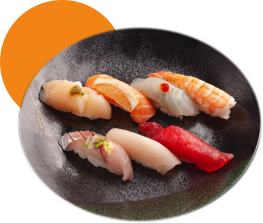 Six pieces of sushi on a black plate, including tuna, salmon, shrimp, and other fish, with garnishes.