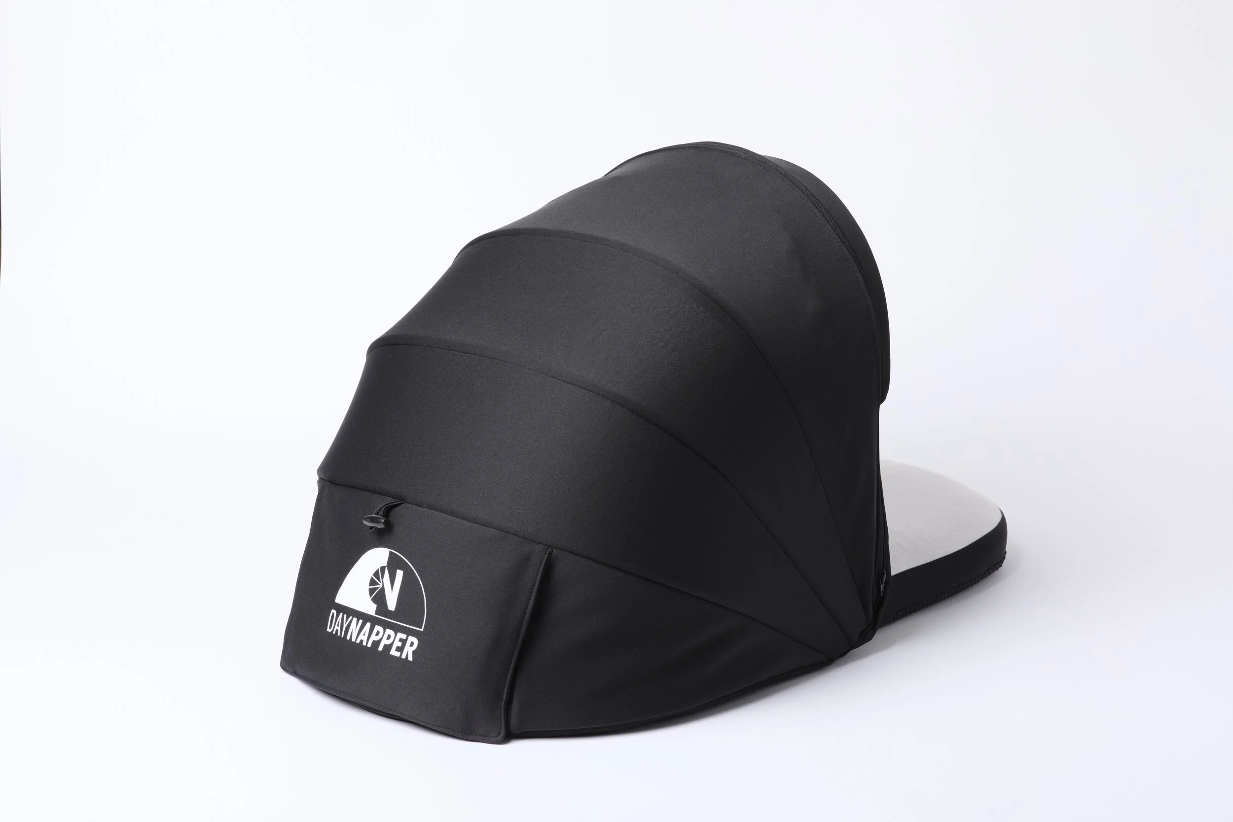 Rear view of DayNapper showing back flap and blackout hood, placed on a white background.