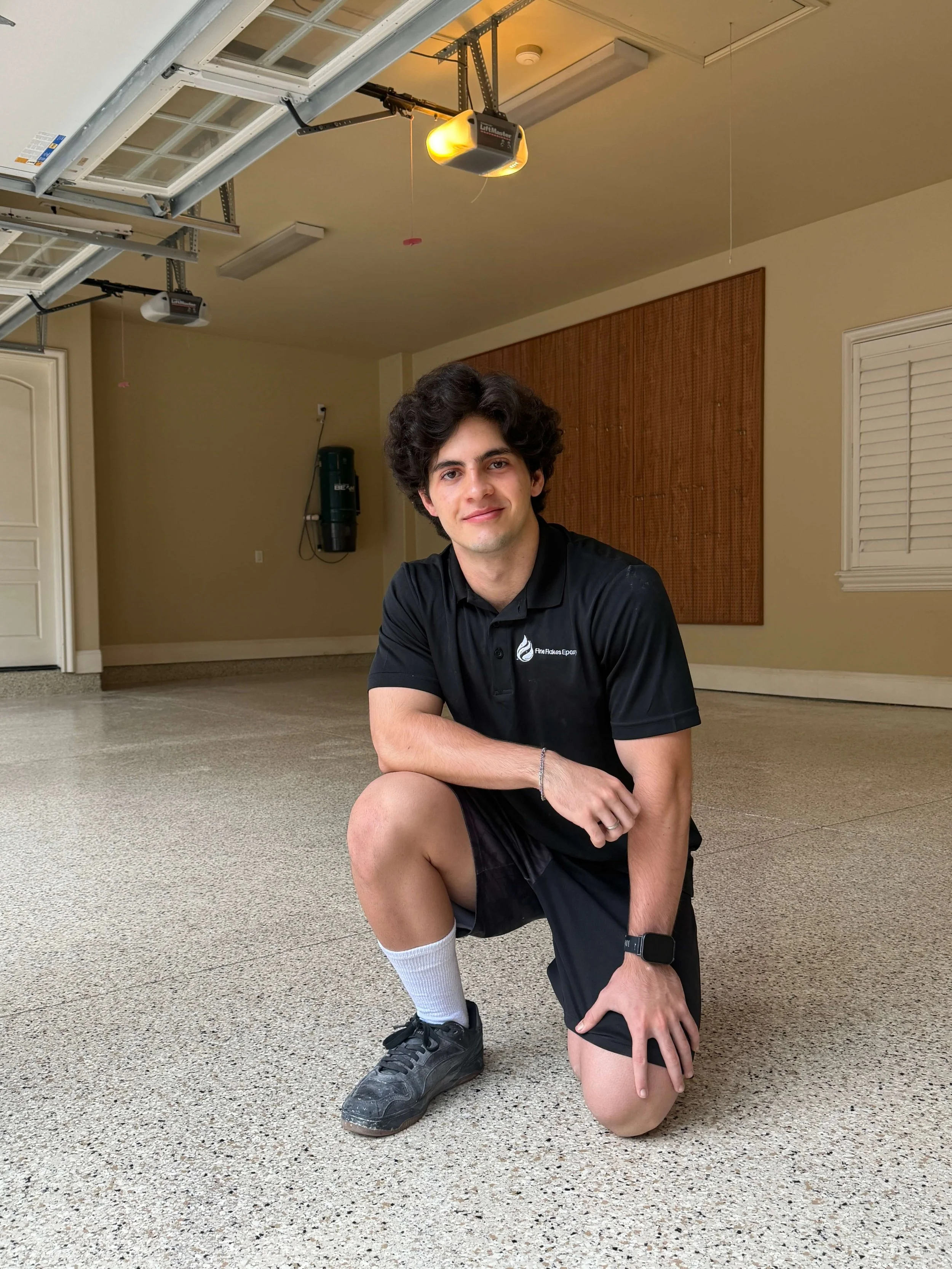 Fine Flakes Epoxy installer showing a freshly coated garage floor in Orlando, Florida