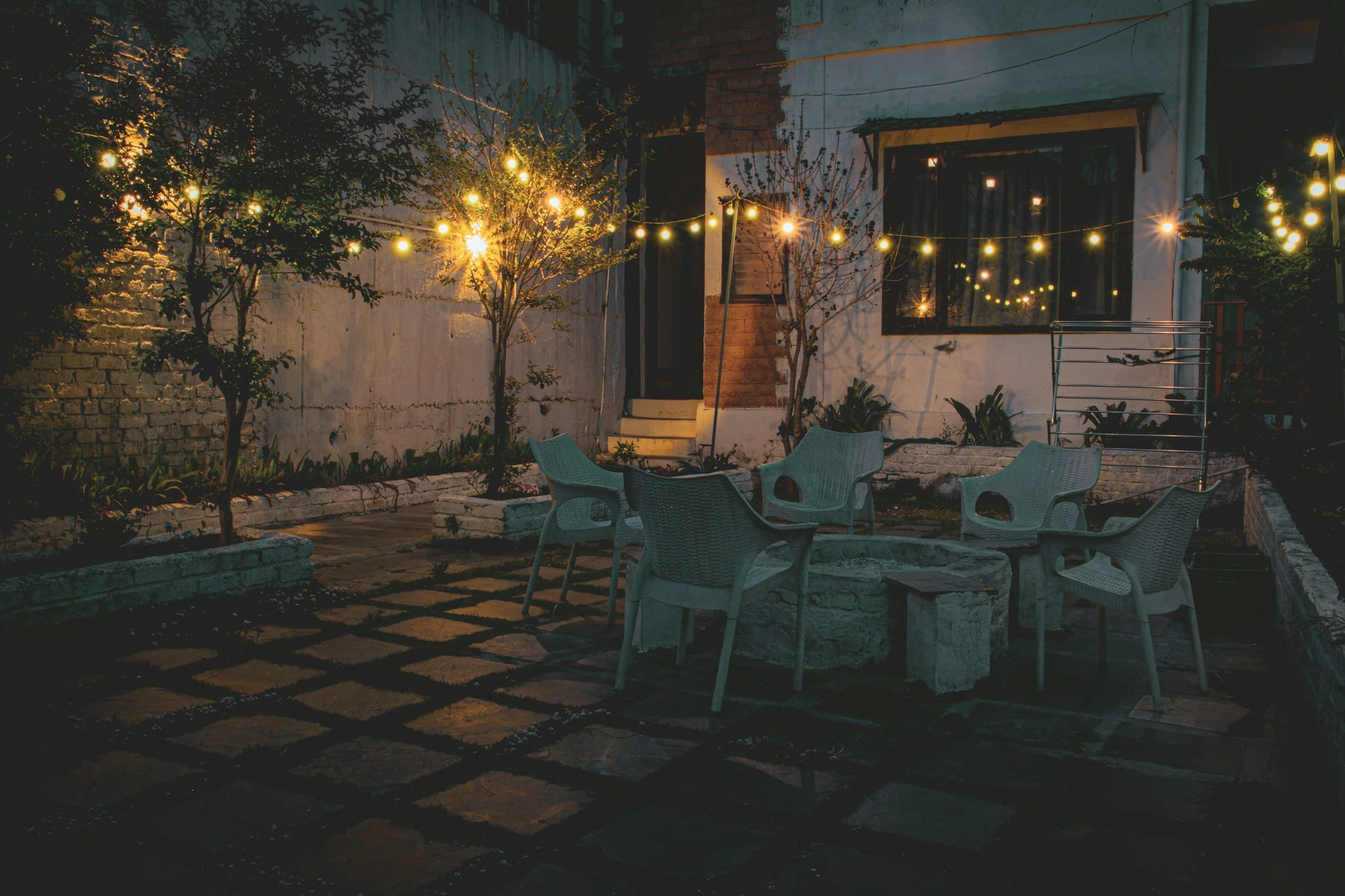 A residential backyard with a refurbished stone paver patio
