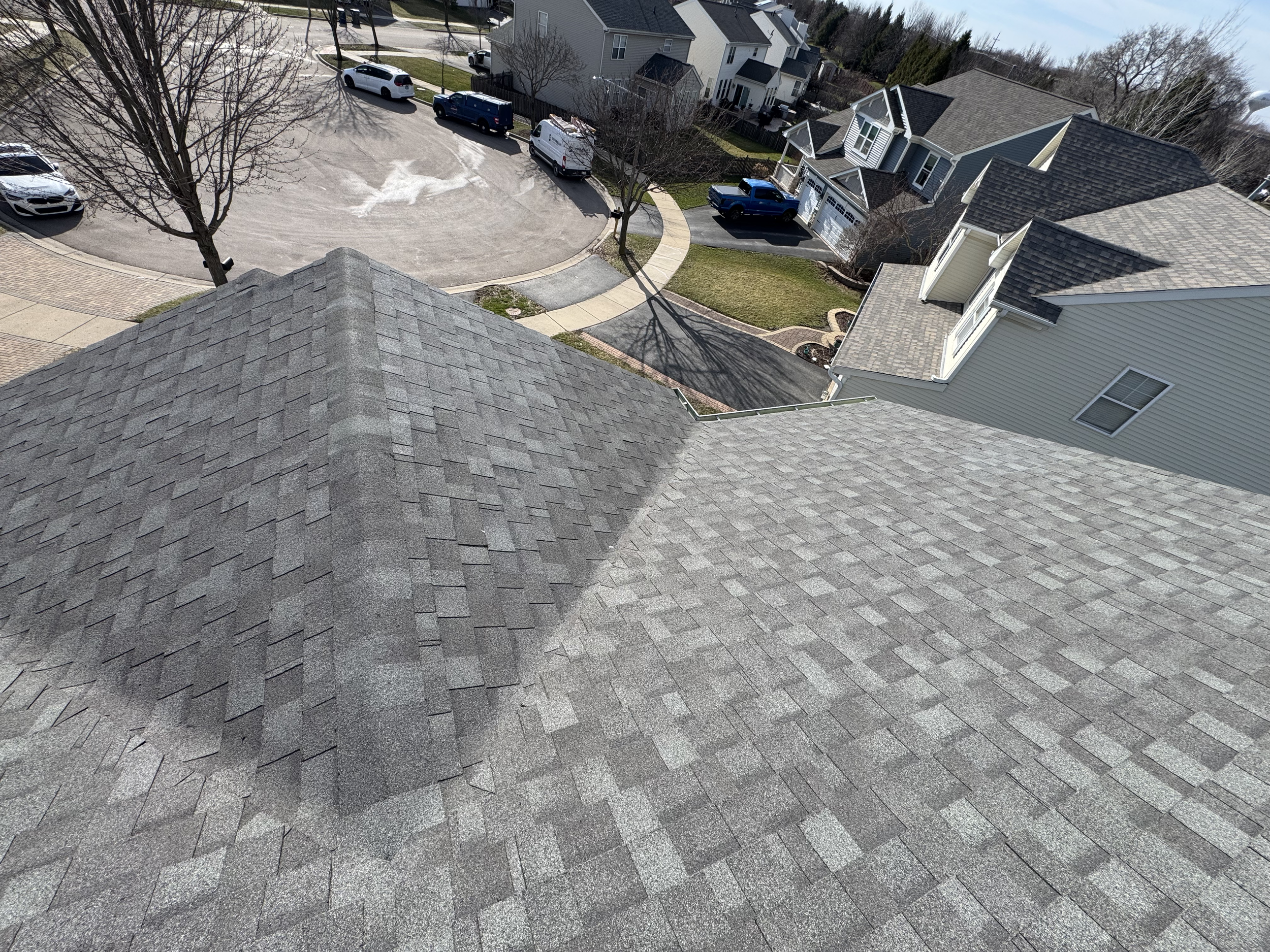 Roof with leak fixed and shingles re-installed over the repaired area
