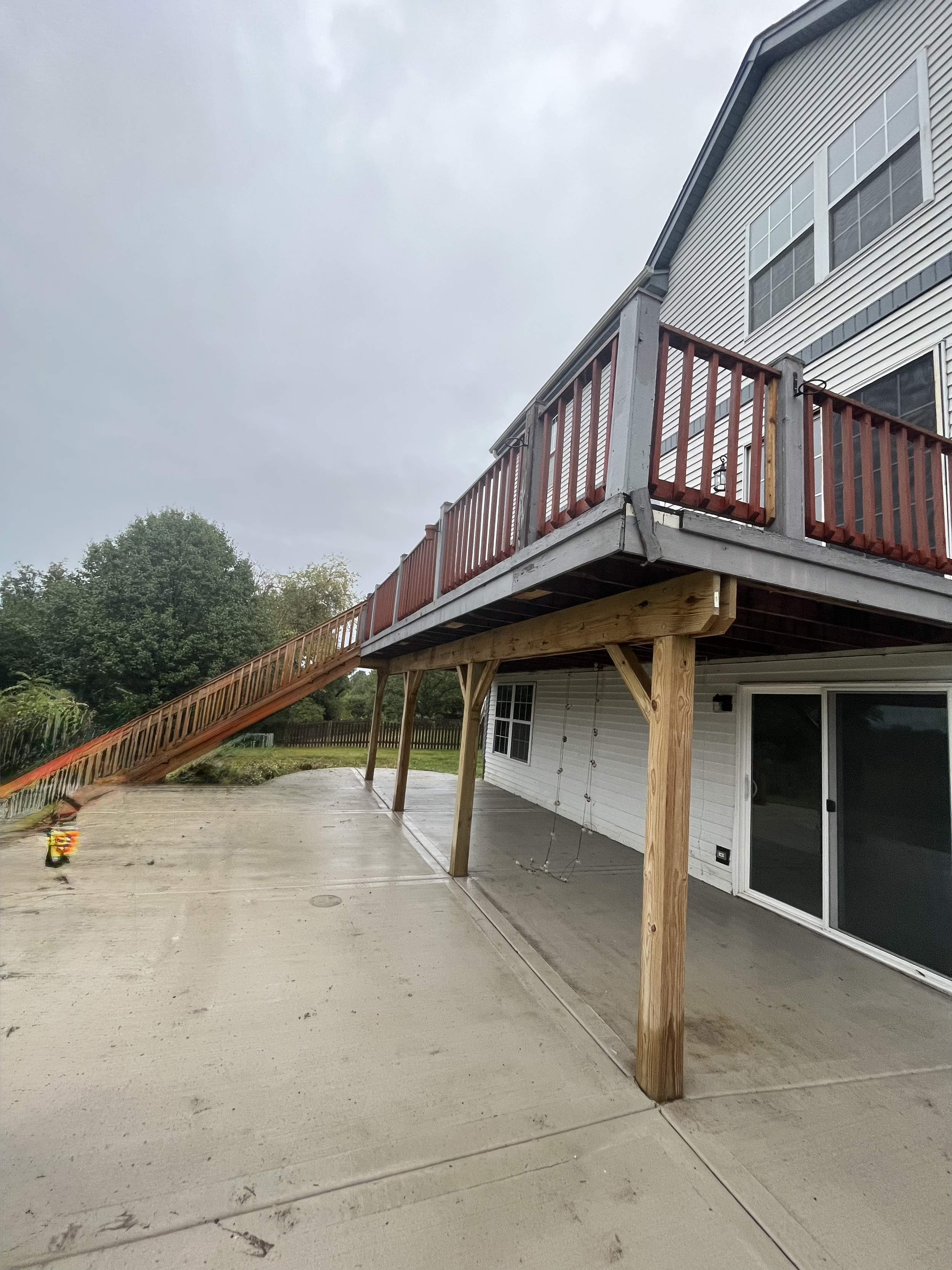 Weathered wood deck before professional sanding, priming, and painting