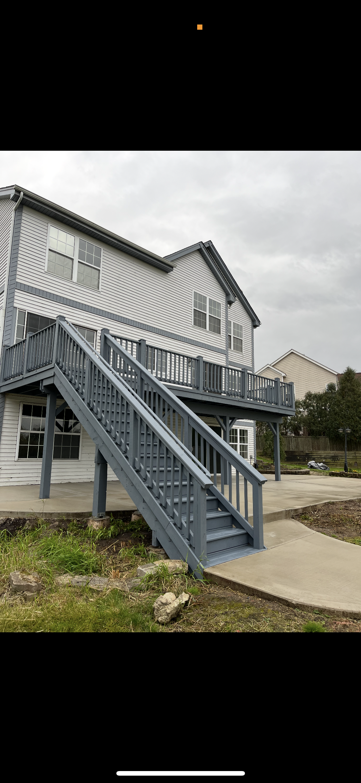 Wooden deck and staircase after being professionally sanded, primed, and stained