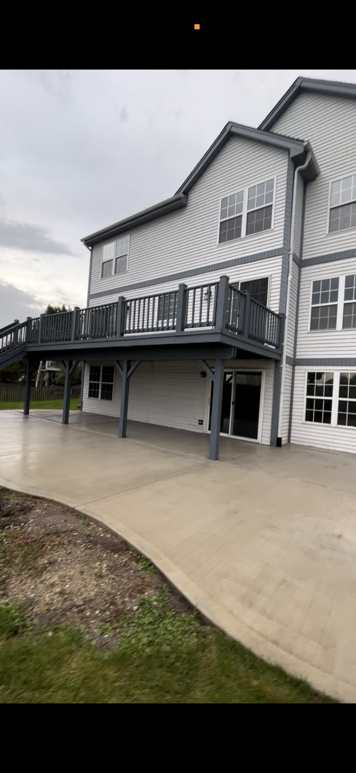 Wooden deck at a residential property after being professionally sanded, primed, and stained