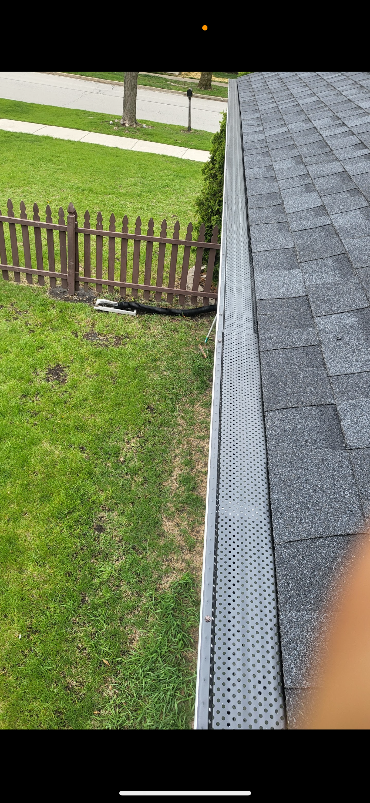 Newly installed gutters with guards and helmets
