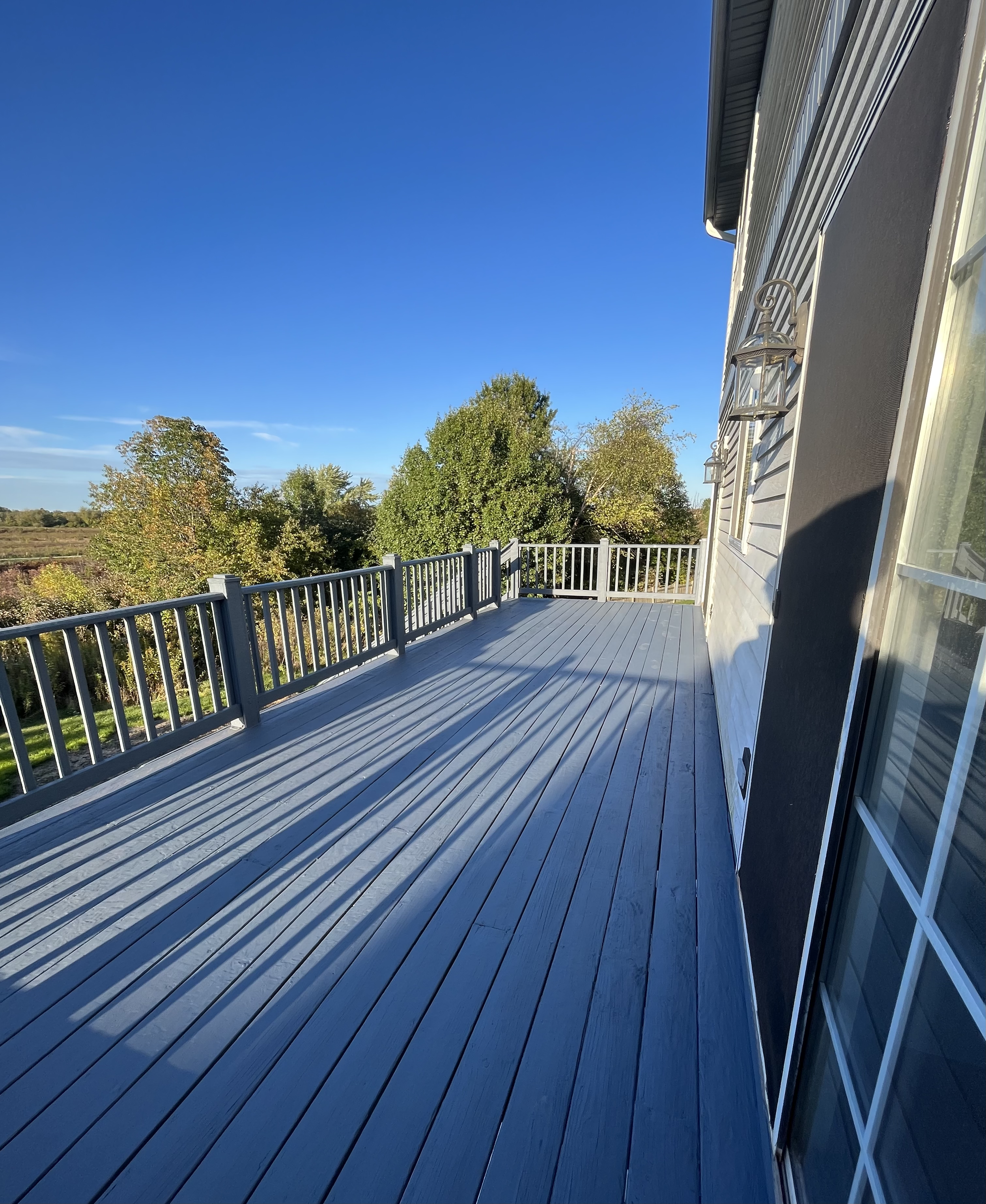 Full deck and railings sanded, primed, and painted.