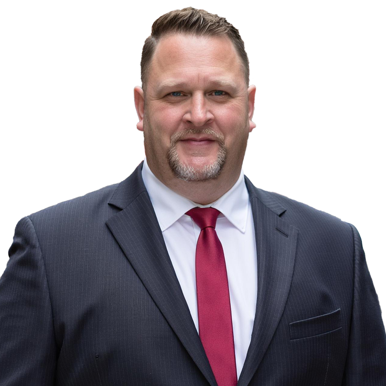 A man in a dark suit, white shirt, and red tie posing for a professional photo.