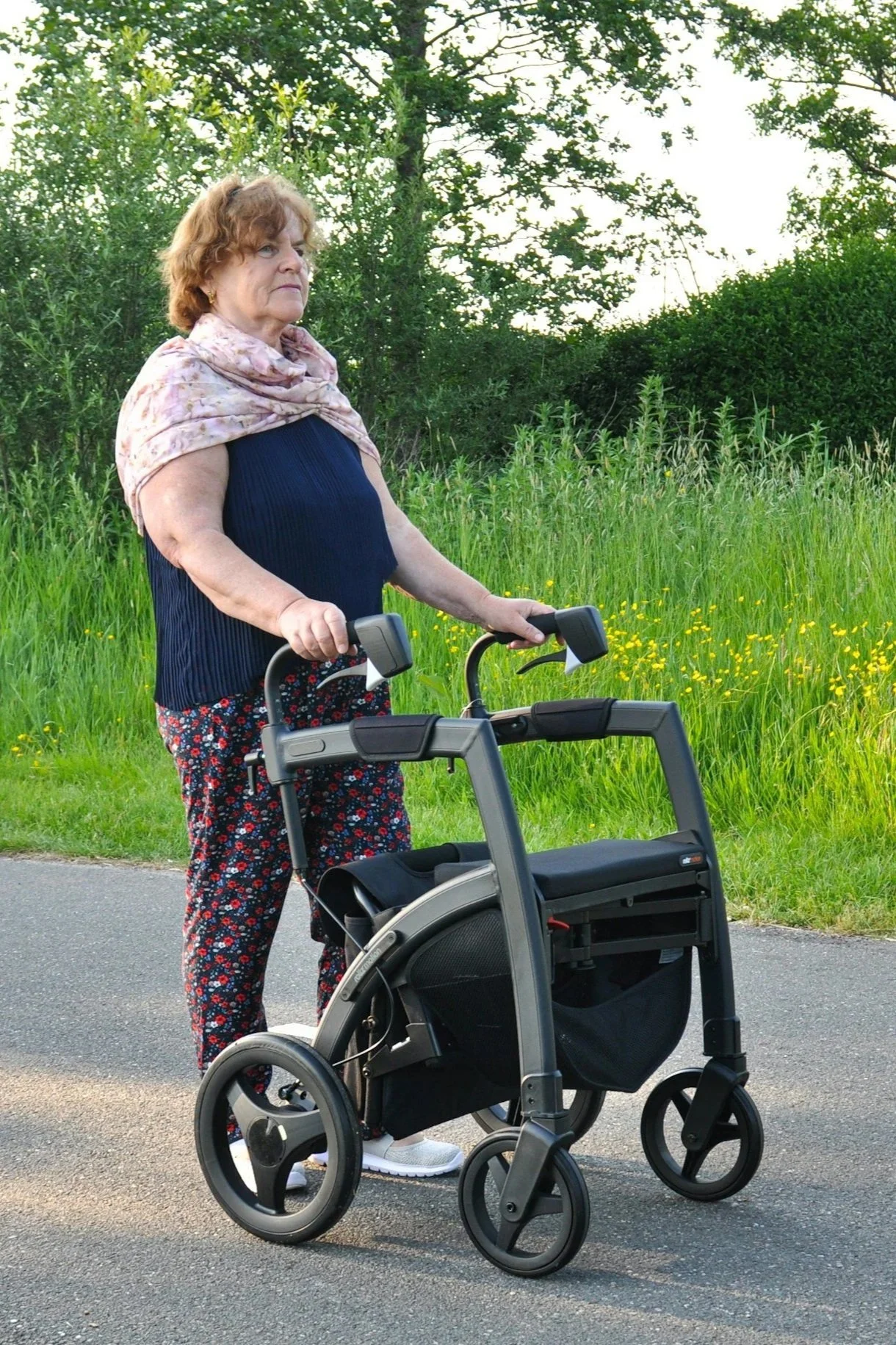 lady walking with a mobility aid or walking frame.