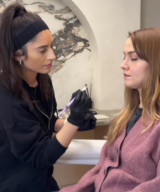 Lip blush technique being applied during a six-week touch up session