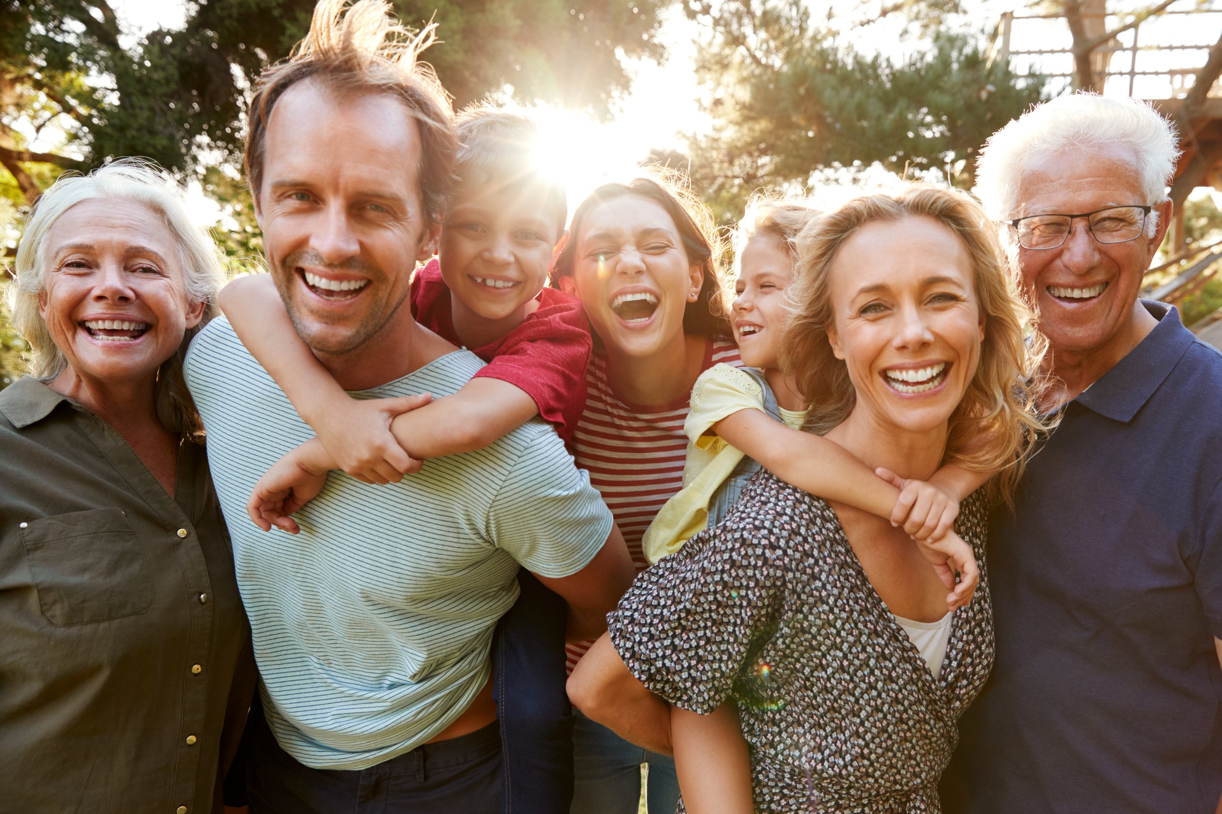 A family smiling and laughing after visiting the dentist