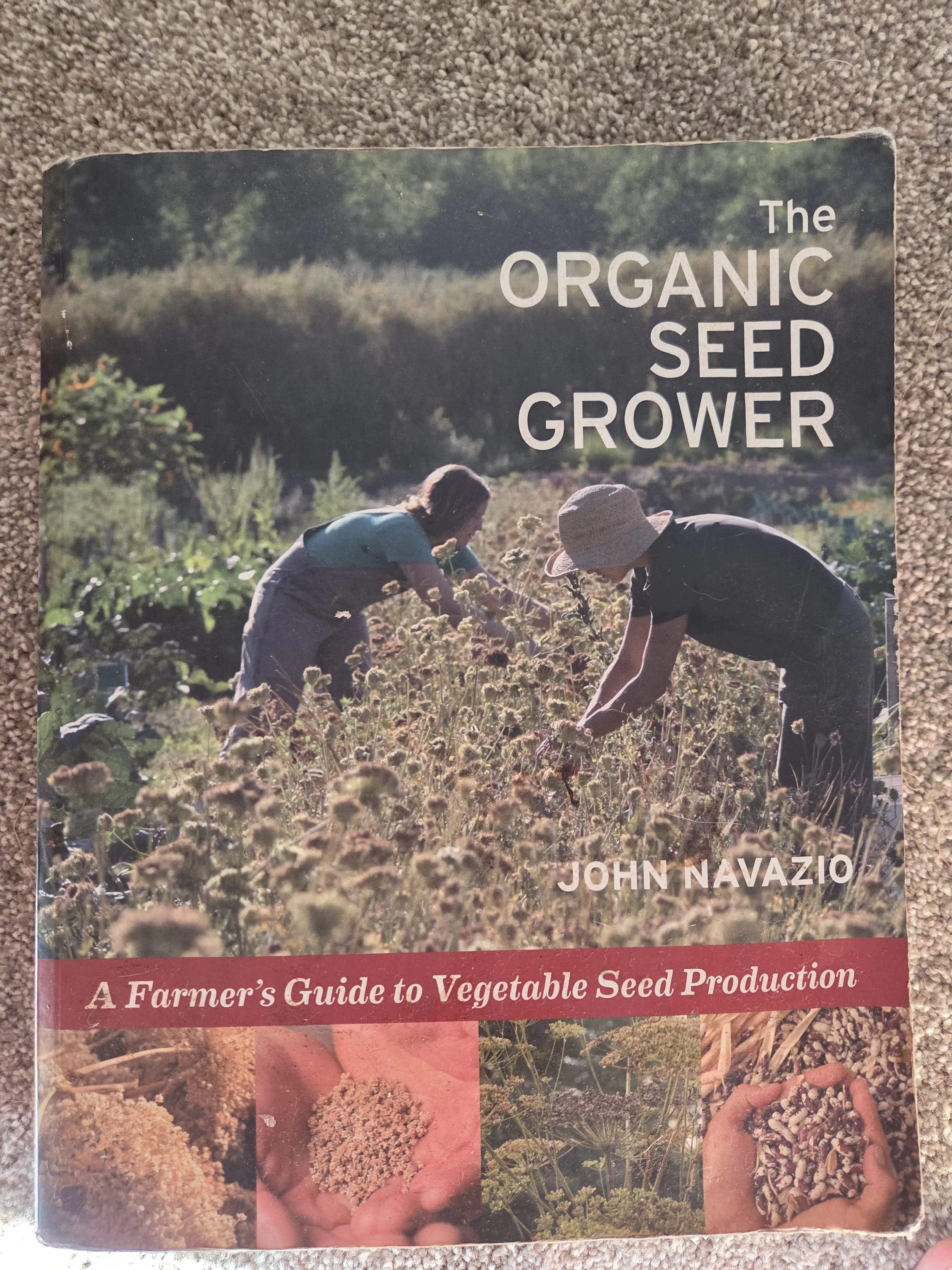 Book cover titled "The Organic Seed Grower" by John Navazio. The cover features two people working in a garden or farm, planting or harvesting vegetables, with additional images of seeds and plants at the bottom.
