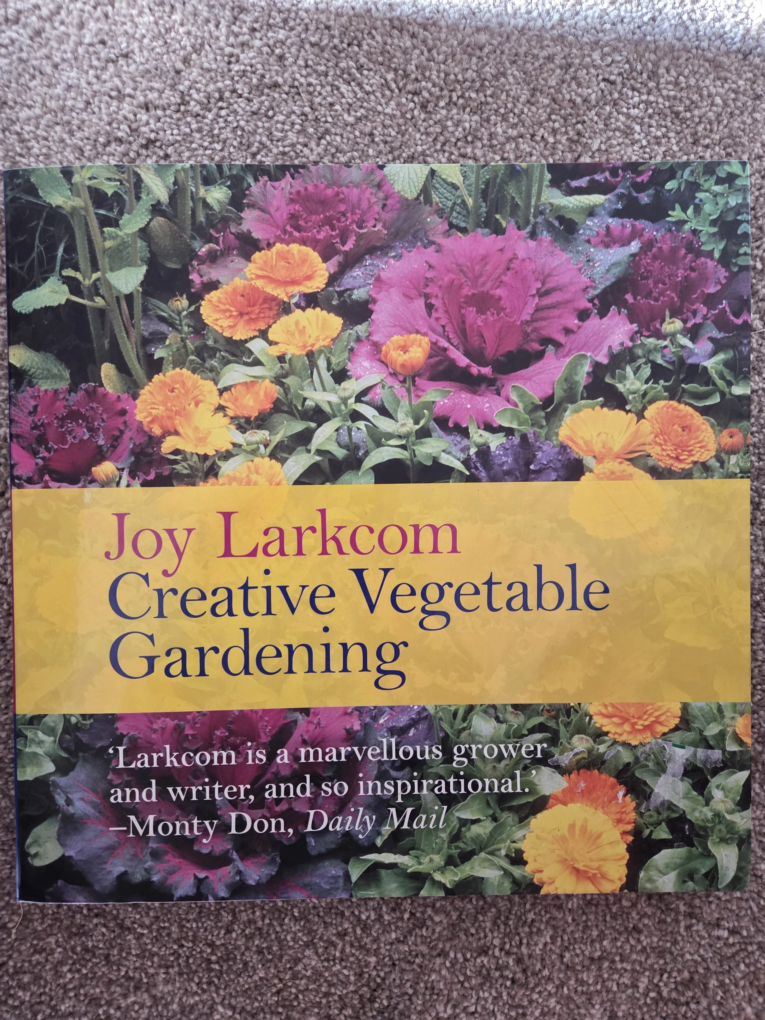 Book cover titled "Creative Vegetable Gardening" by Joy Larkcom, featuring colorful vegetables and flowers.
