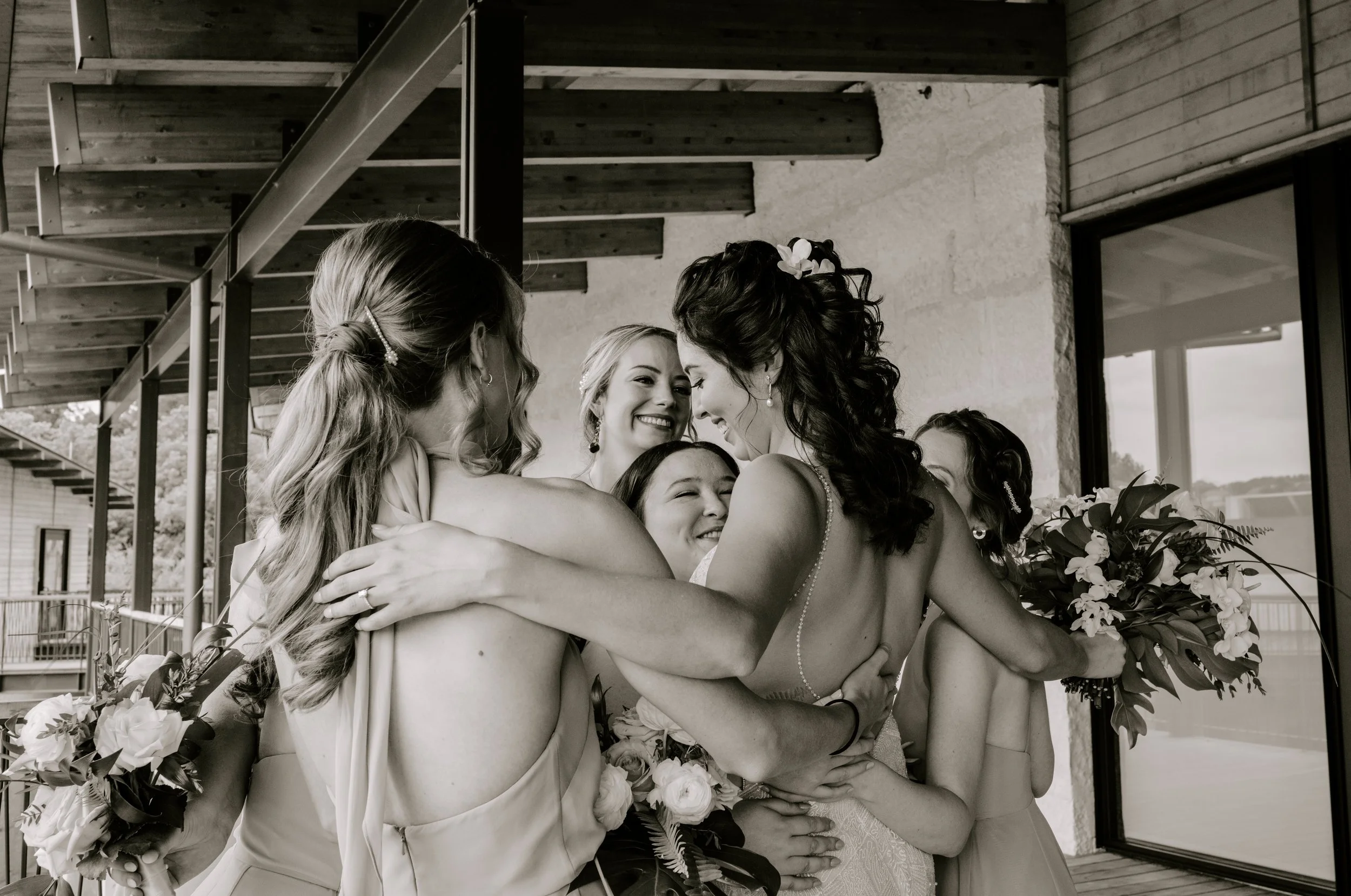 Candid documentary wedding moment of loved ones embracing during a Seattle wedding.