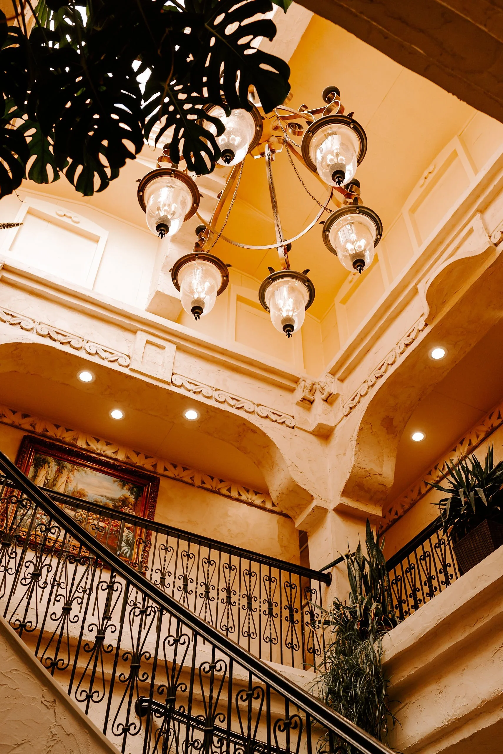 Editorial wedding photography of a historic Seattle wedding venue interior with chandelier and staircase