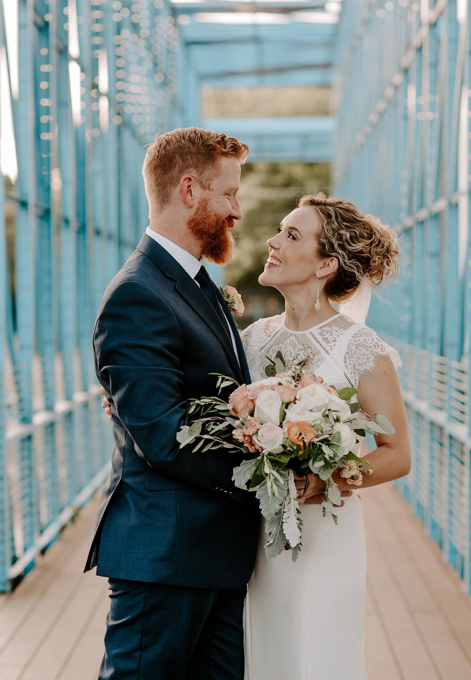 Artful modern wedding portrait of a couple on a bridge in Seattle photographed by a Seattle wedding photographer.