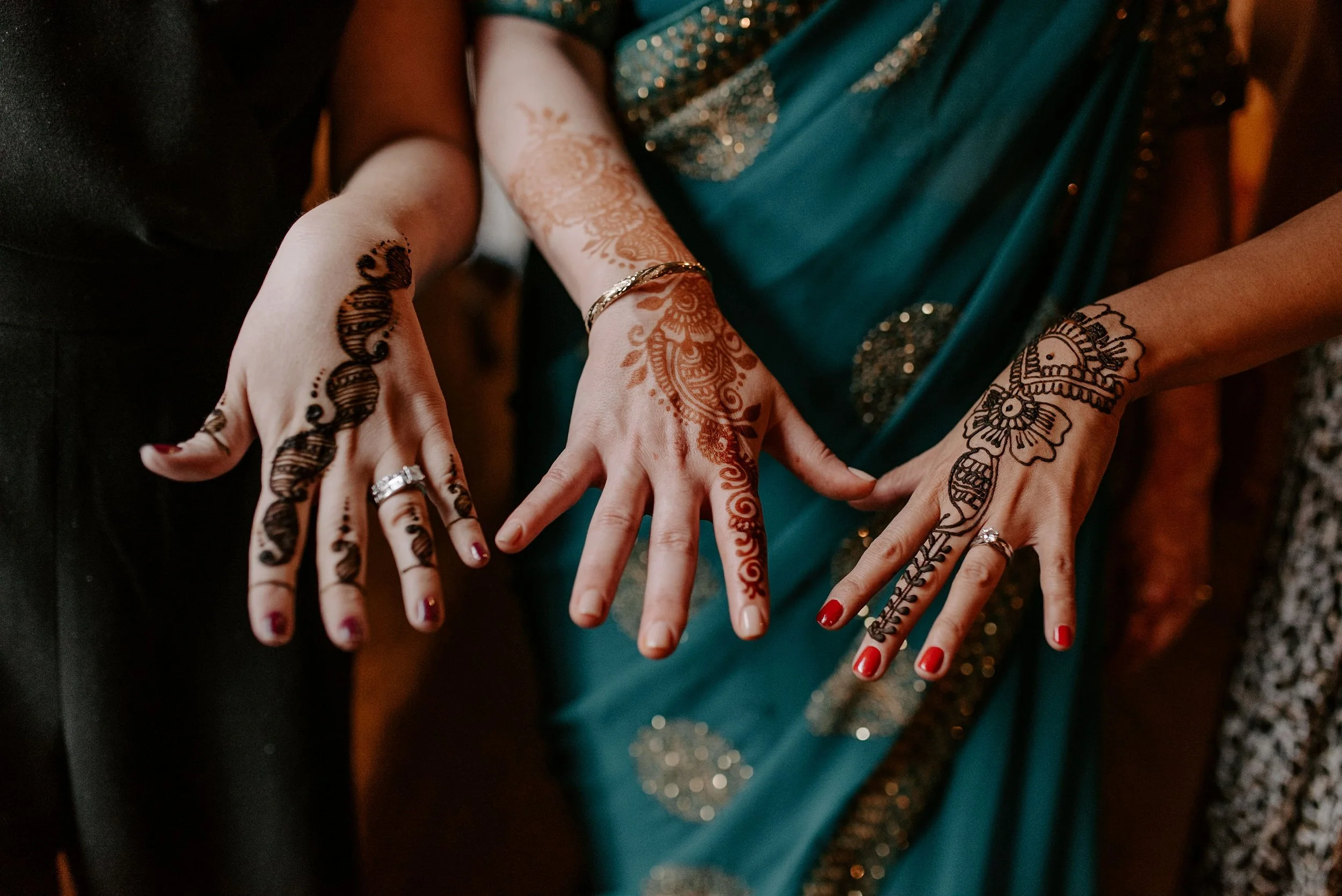 Cultural wedding detail featuring henna-adorned hands photographed at a Seattle wedding.