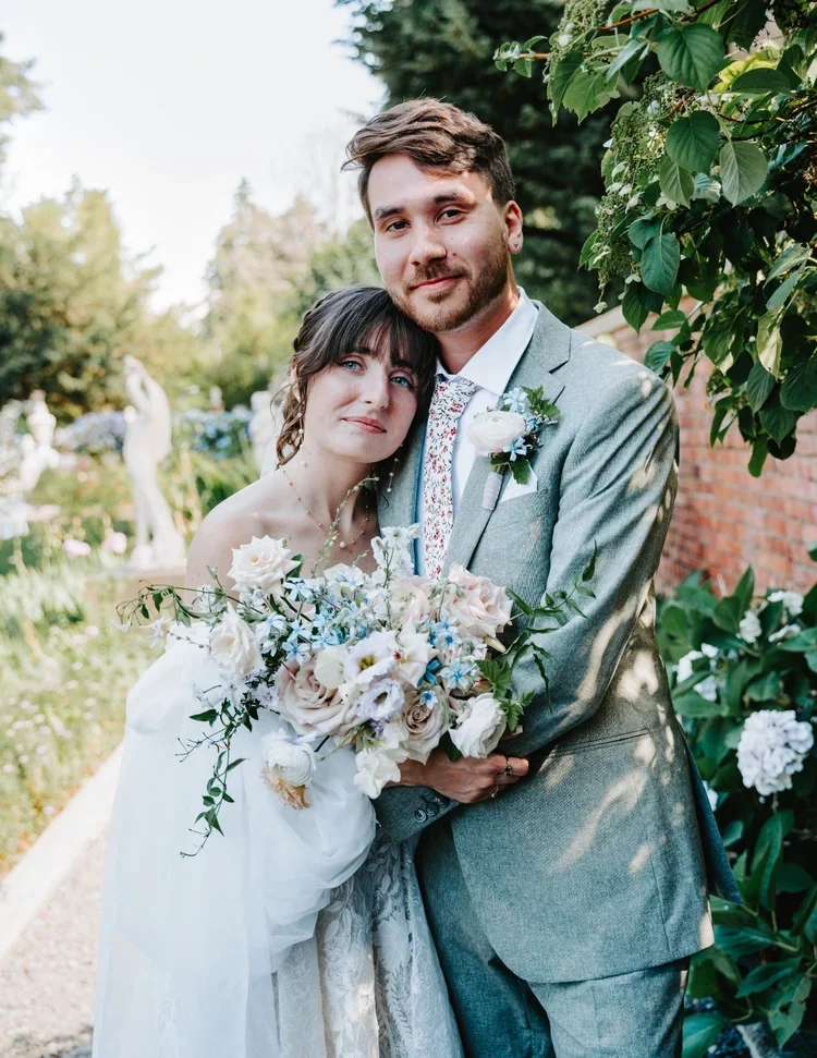 Editorial wedding portrait of a couple surrounded by greenery photographed by a Seattle wedding photographer.