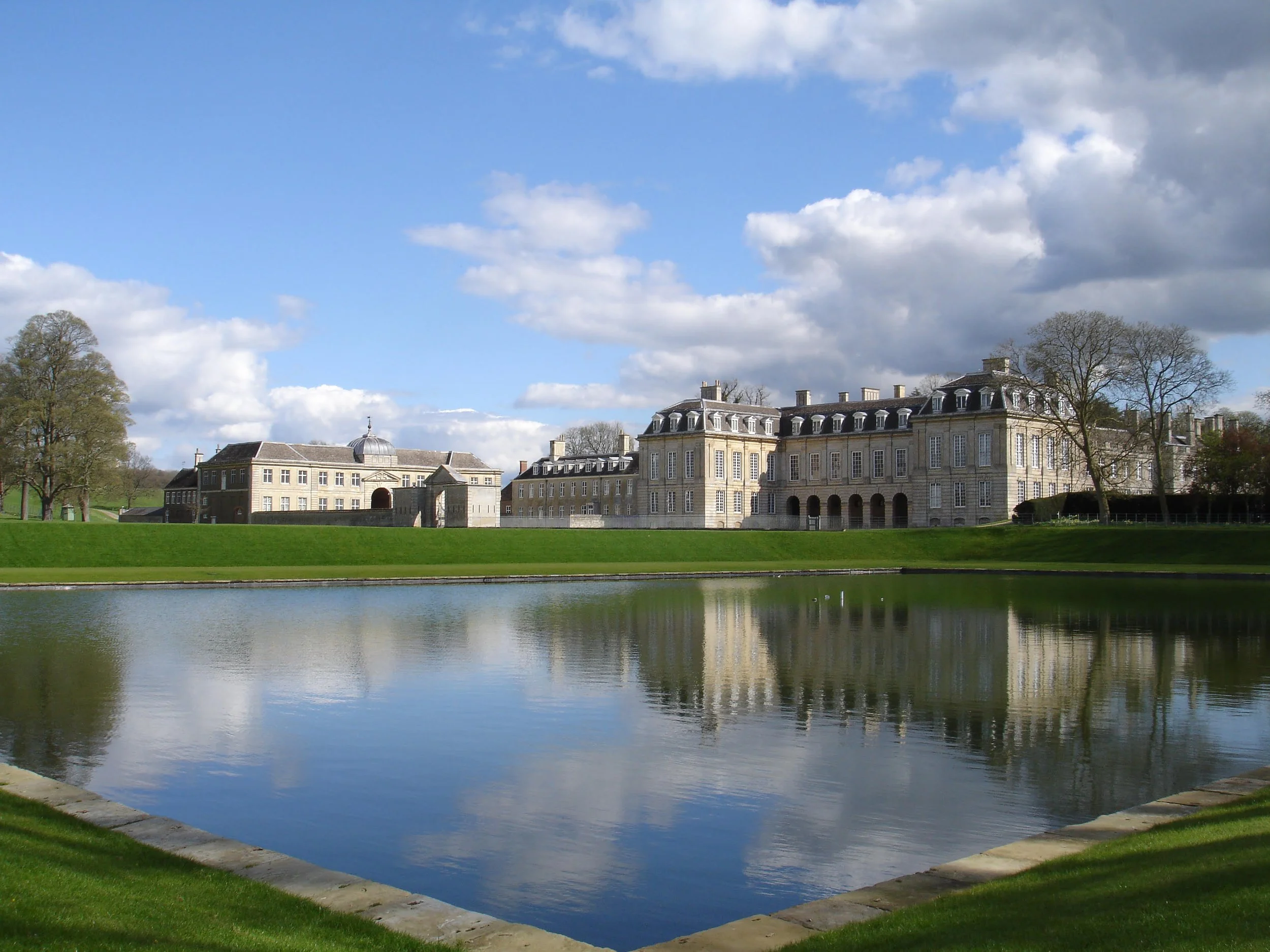 Boughton House reflected in the Grand Etang, one of the earliest surviving features from the original gardens and designed landscape.