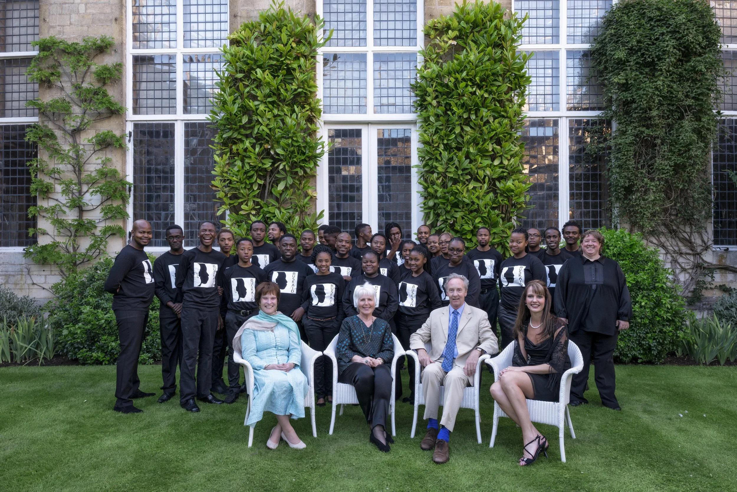 The Buskaid String Ensemble, photographed with with their inspired director Rosemary Nalden MBE and the Duke and Duchess of Buccleuch. The Buskaid String Ensemble is a musical miracle from Soweto; their concert in the Great Hall at Boughton House in 
