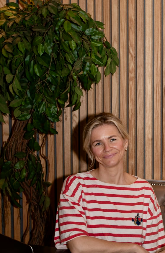 Light haired woman in red striped jumper smiling to the camera; Cathrine Merkesdal