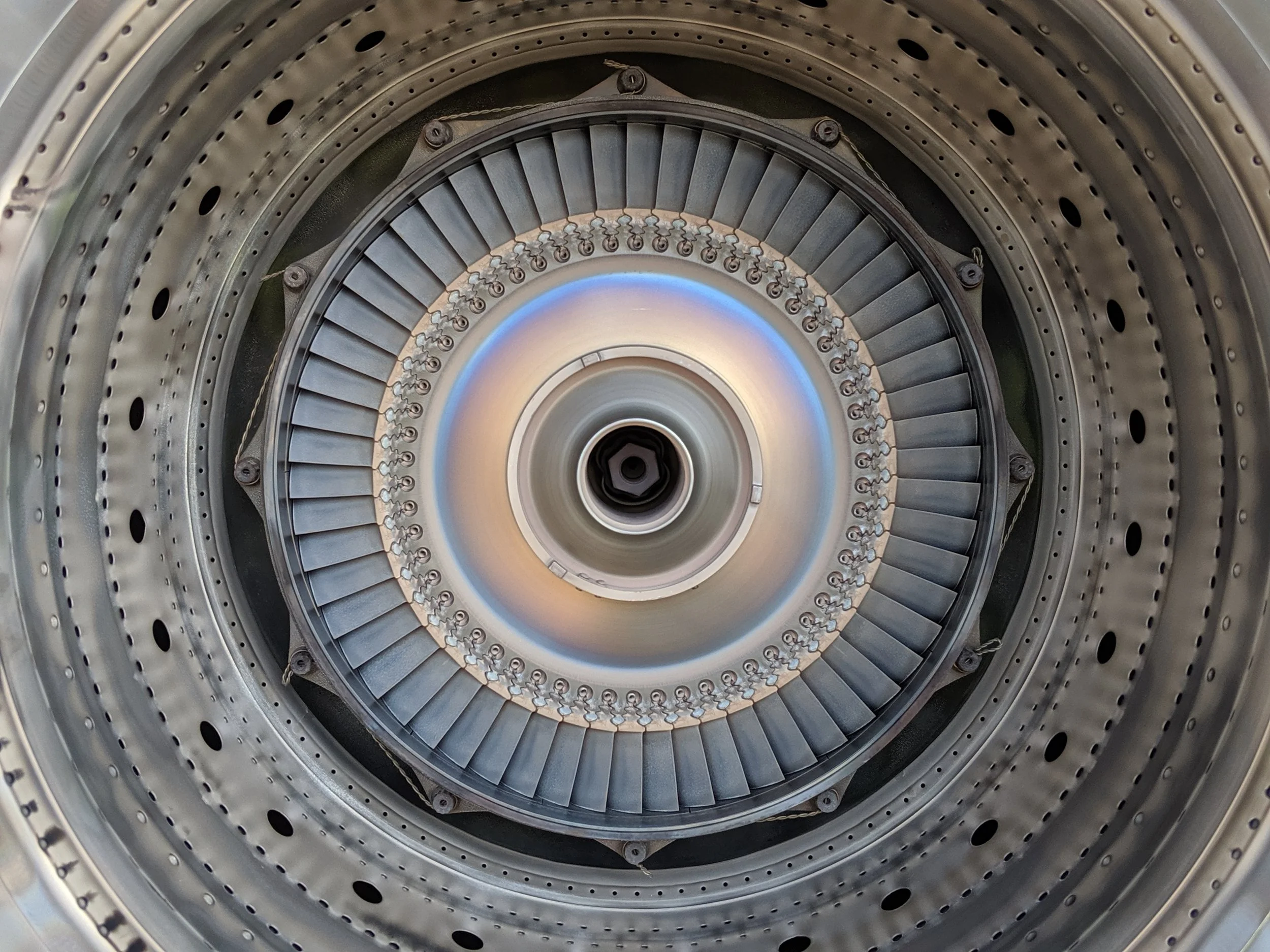 Close-up view inside a PT6 engine's turbine, showing multiple blades and hot section components.