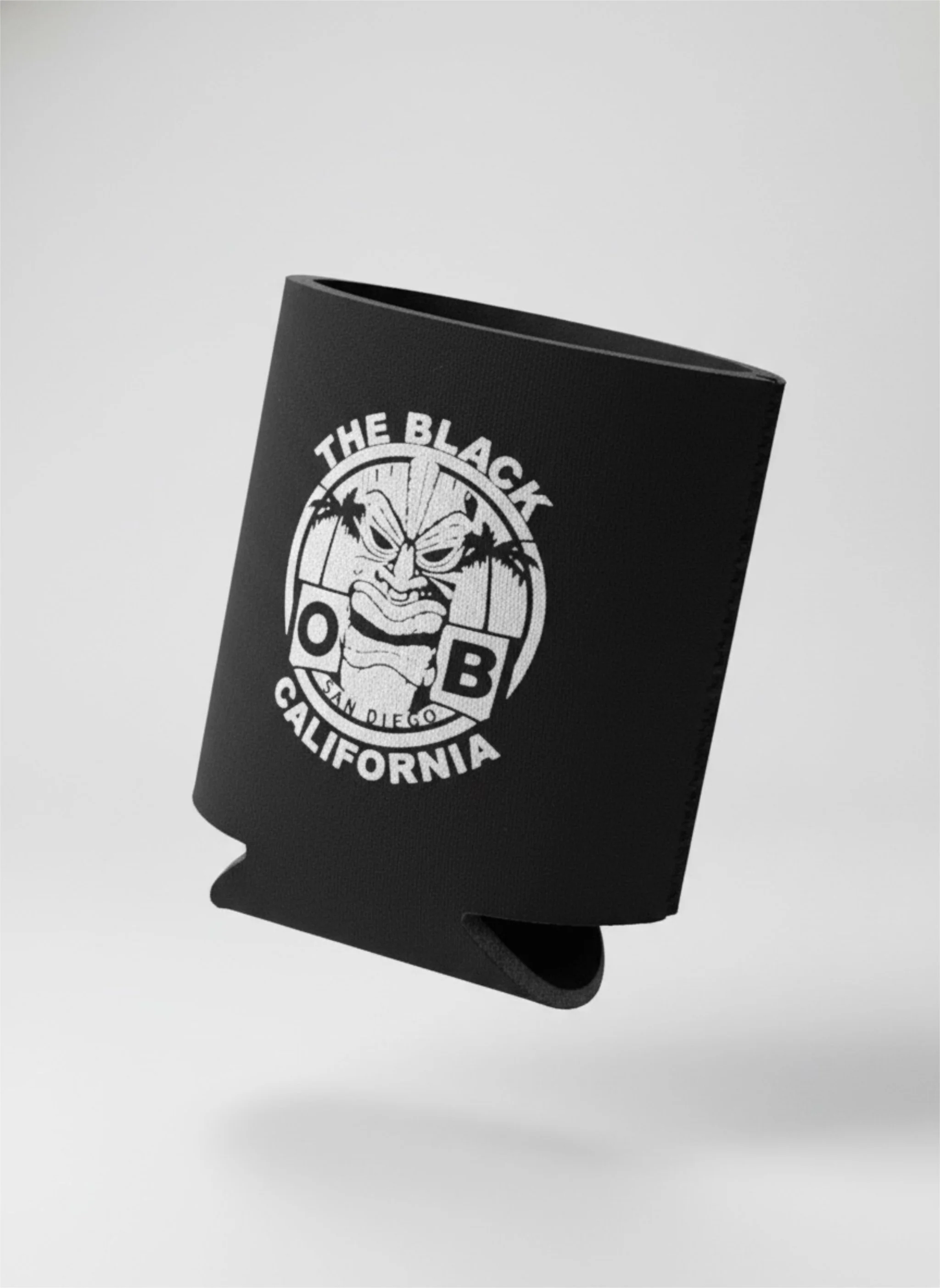 A black can cooler with a logo reading 'The Black O B California San Diego' featuring a stylized face with a fierce expression and palm trees.